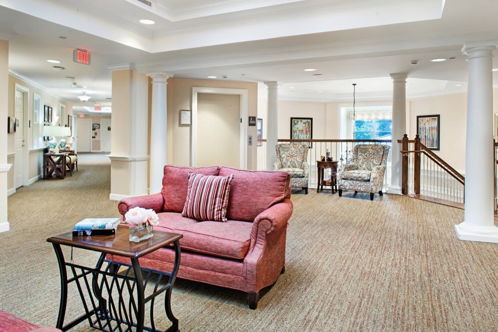 A cozy living room interior with a red sofa and elegant decor.