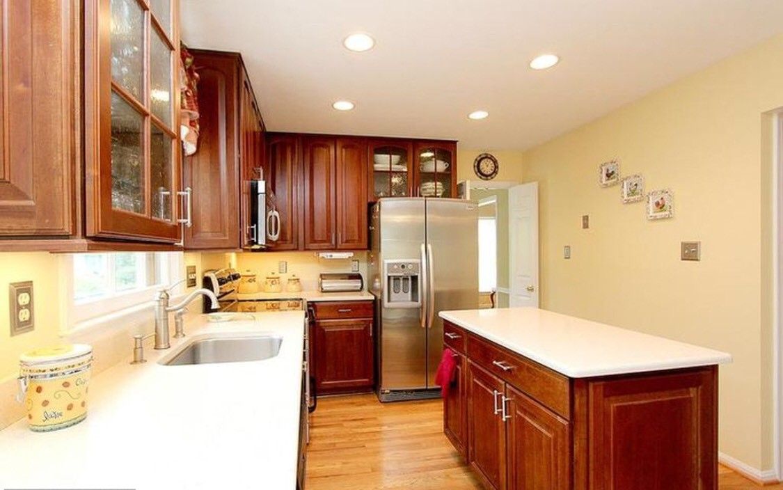 A modern kitchen with wood cabinets and stainless steel appliances.