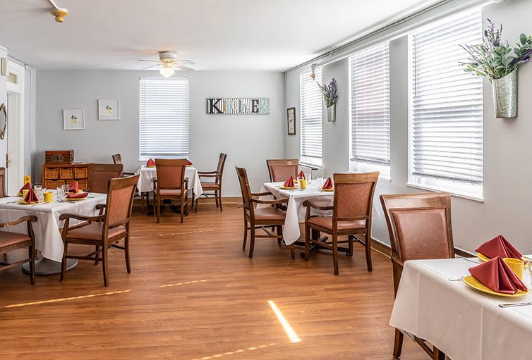 A bright and inviting dining room with neatly arranged tables and chairs.