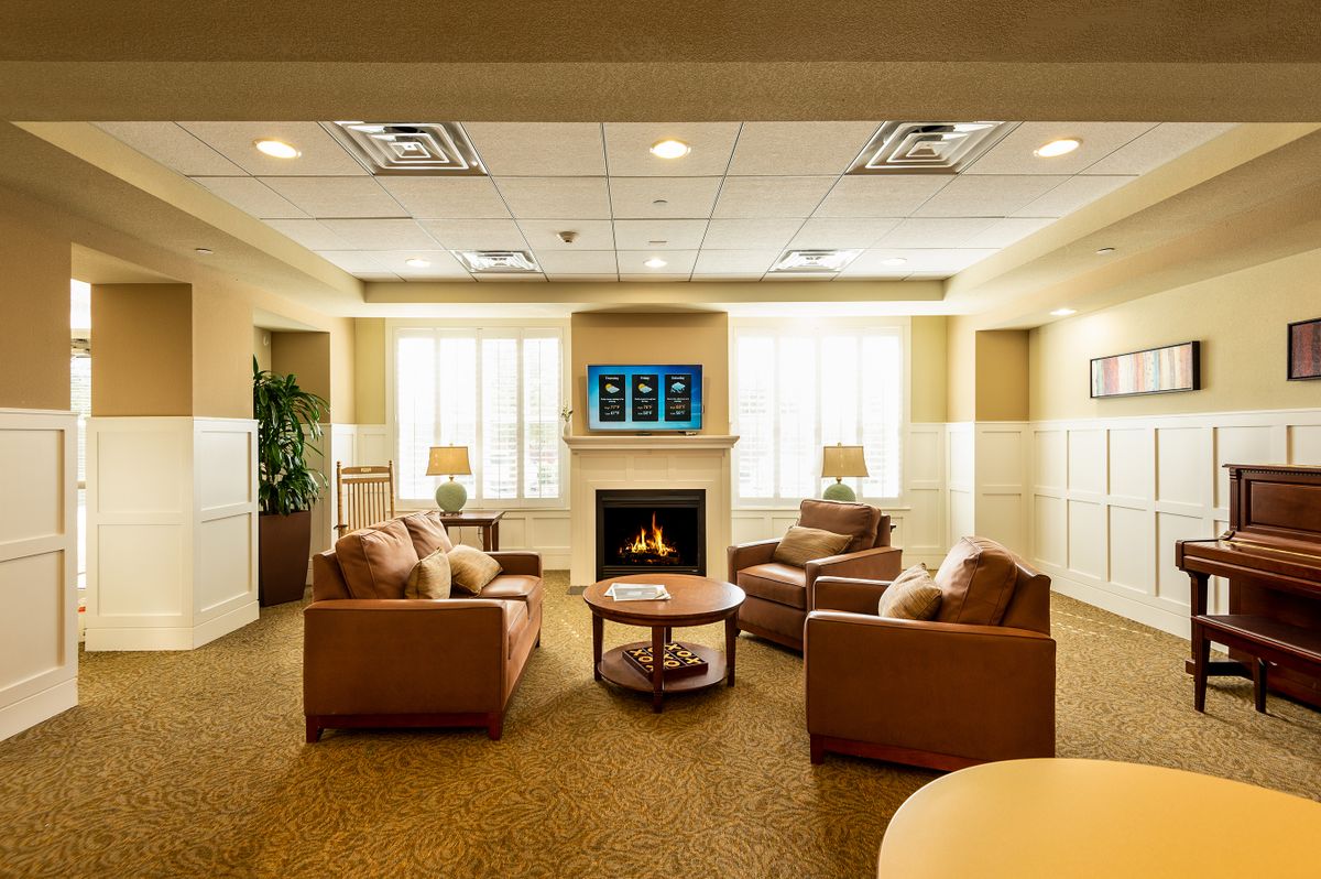 A cozy lounge area featuring comfortable armchairs and a fireplace.