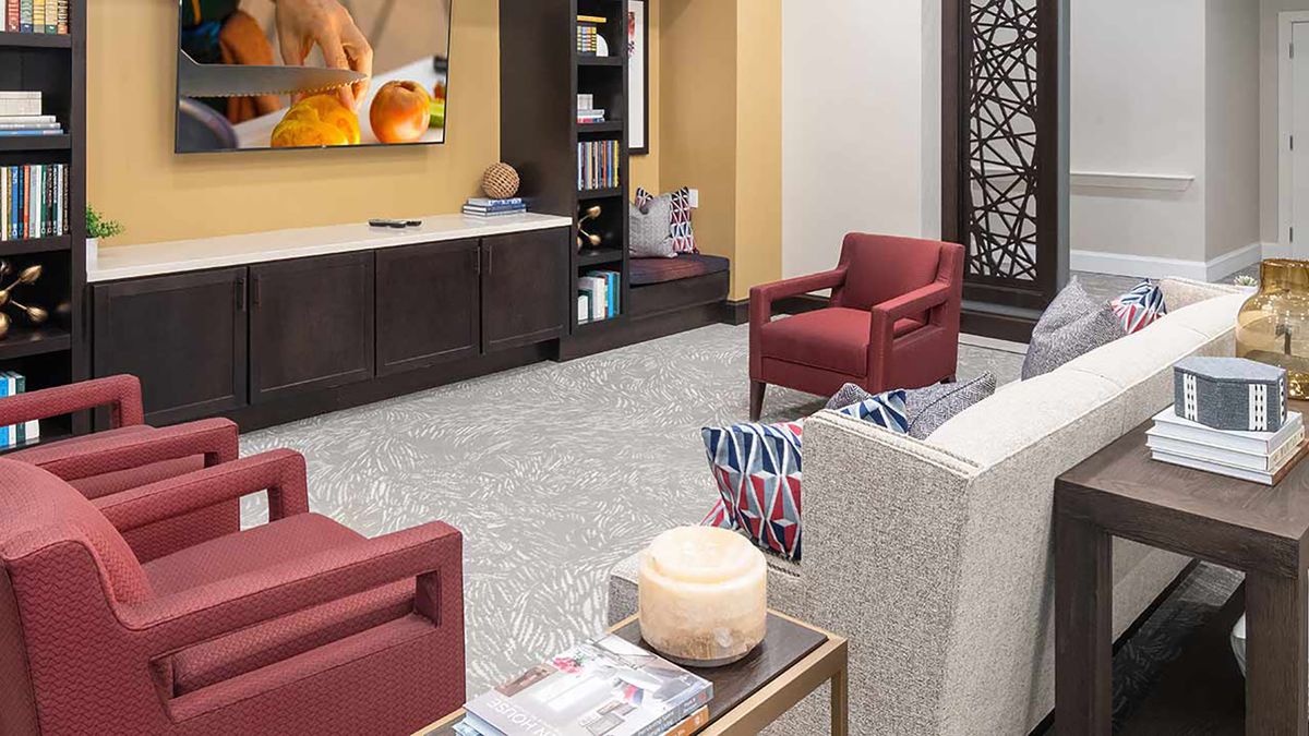 A modern living room with stylish furniture and a television centerpiece.