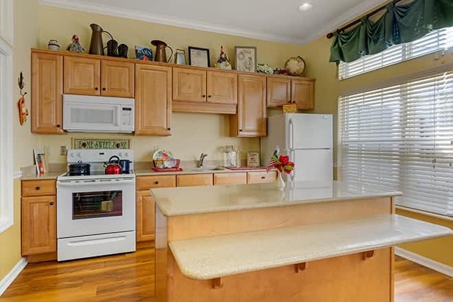 A cozy kitchen with wooden cabinets and modern appliances.