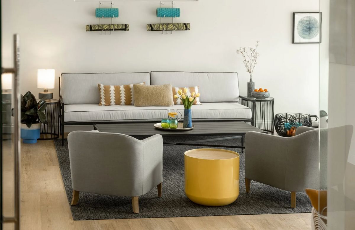 A modern living room with stylish furniture, including a sofa, chairs, and a coffee table.