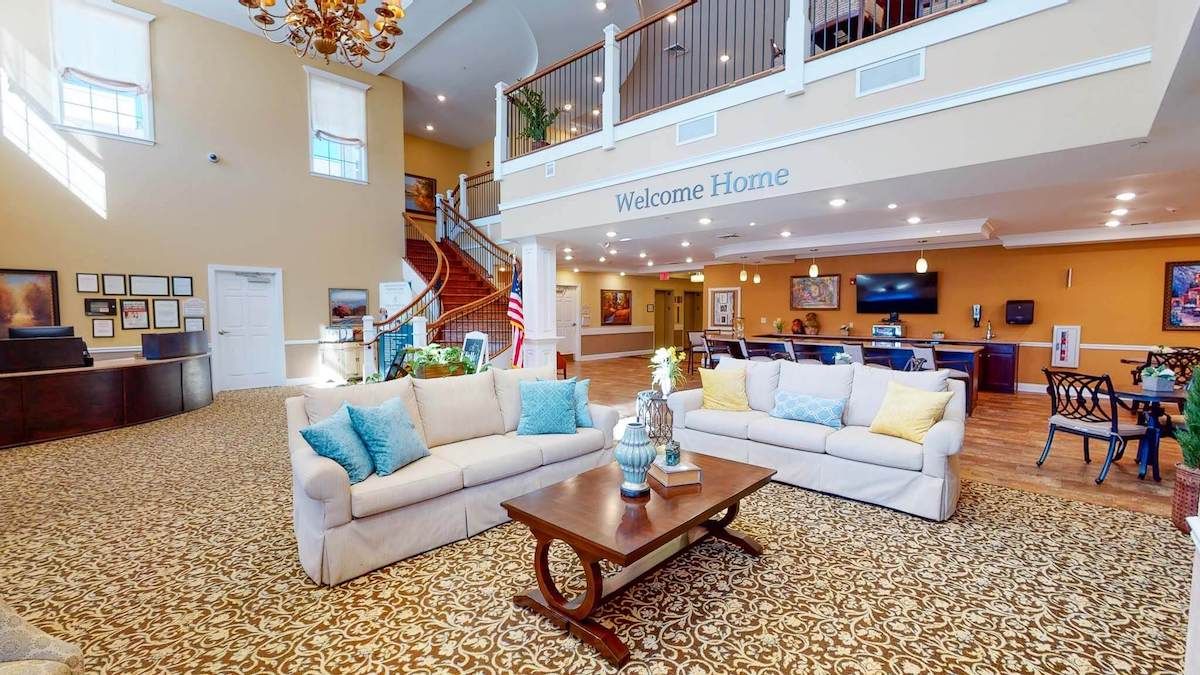 A welcoming hotel lobby with comfortable sofas, elegant decor, and a chandelier.
