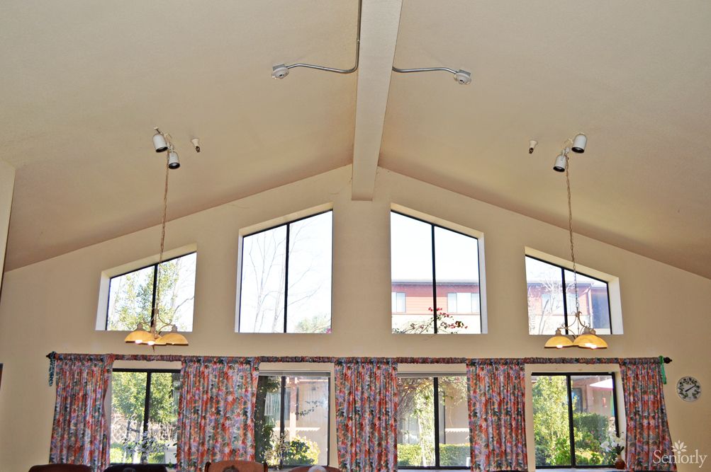 A spacious interior with high ceilings and large windows, allowing abundant natural light to enter.