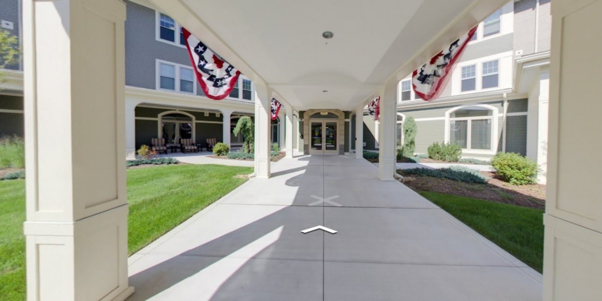 A building entrance decorated with red, white, and blue banners.
