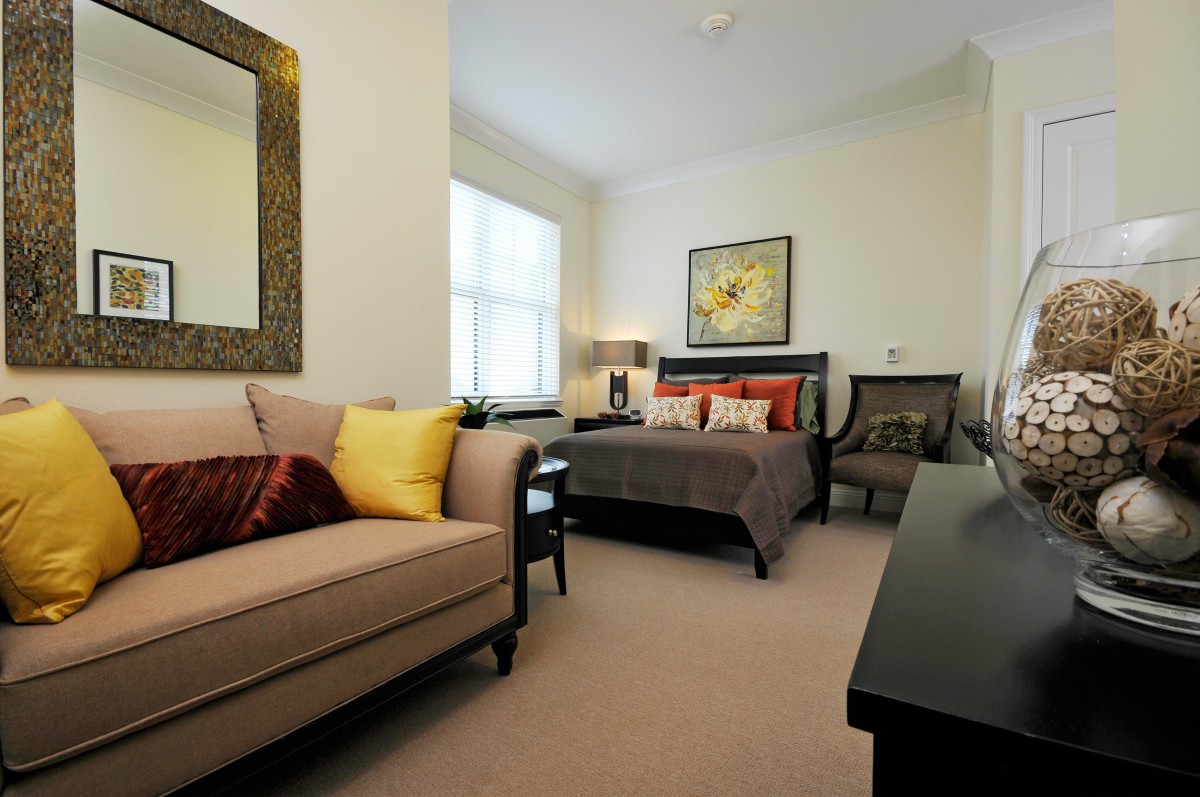 A modern bedroom featuring a comfortable bed, elegant sofa, and stylish decor.