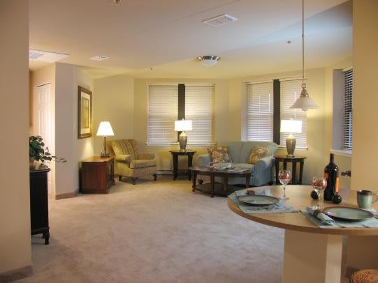 A cozy living room with comfortable seating and warm lighting.