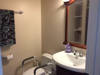 A small, well-organized bathroom with essential amenities.