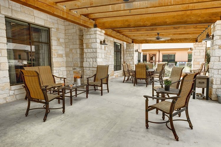 An inviting outdoor patio with comfortable seating and a wooden pergola.