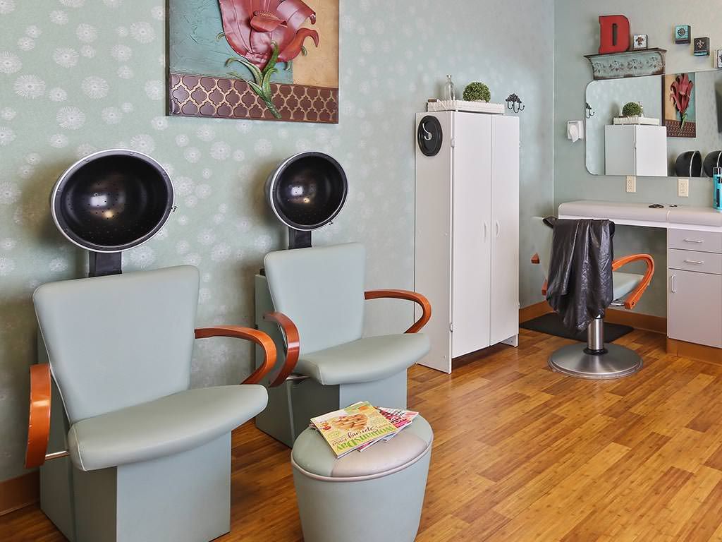 A vintage-themed hair salon interior with retro hair dryers and stylish decor.