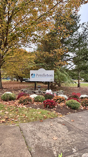 A welcoming sign amidst the colorful autumn foliage.