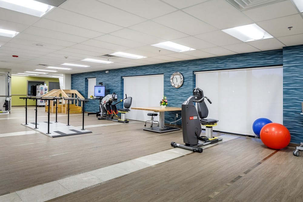 A rehabilitation center featuring exercise equipment and therapy space.