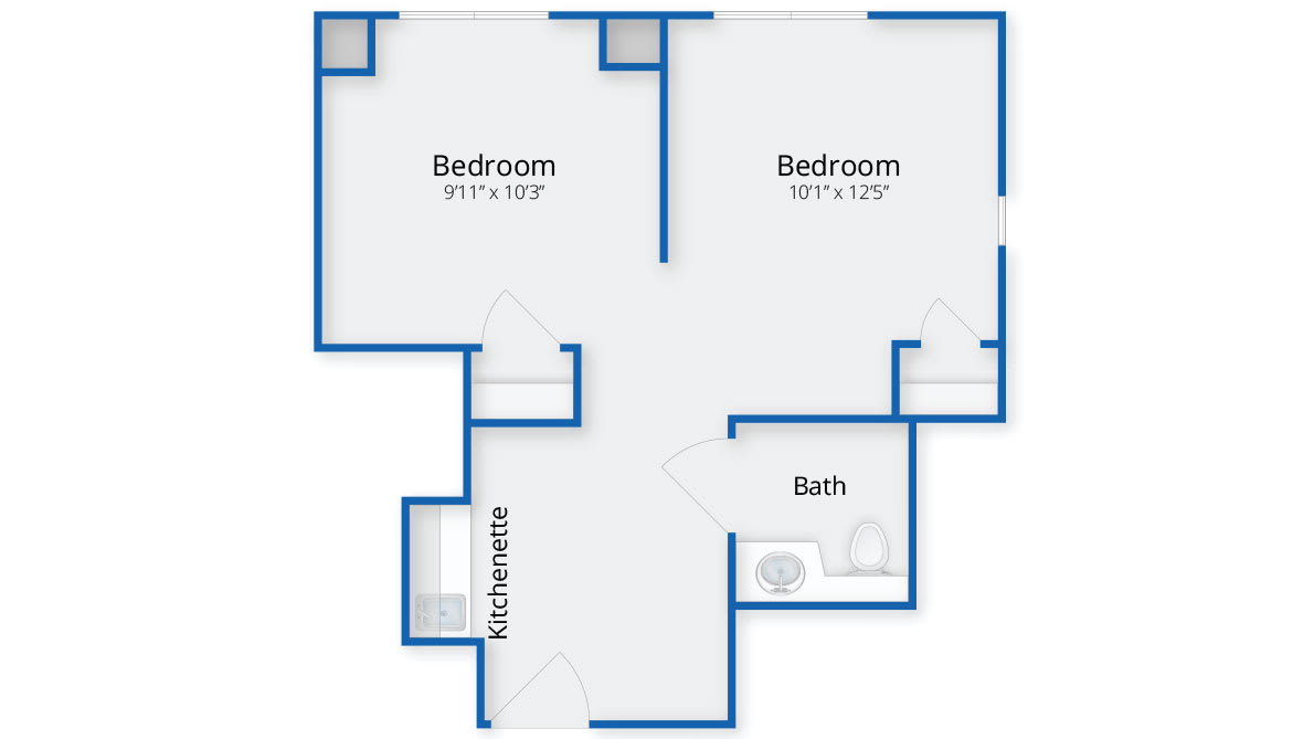 A floor plan featuring two bedrooms, a bathroom, and a kitchenette.