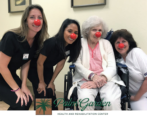 Caregivers and residents share a joyful moment with playful clown noses.