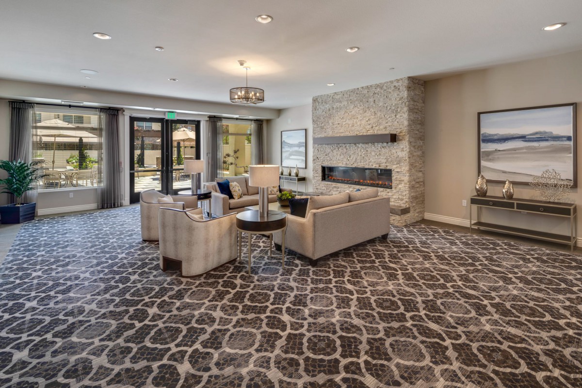 A modern living room with stylish furniture and a cozy fireplace.