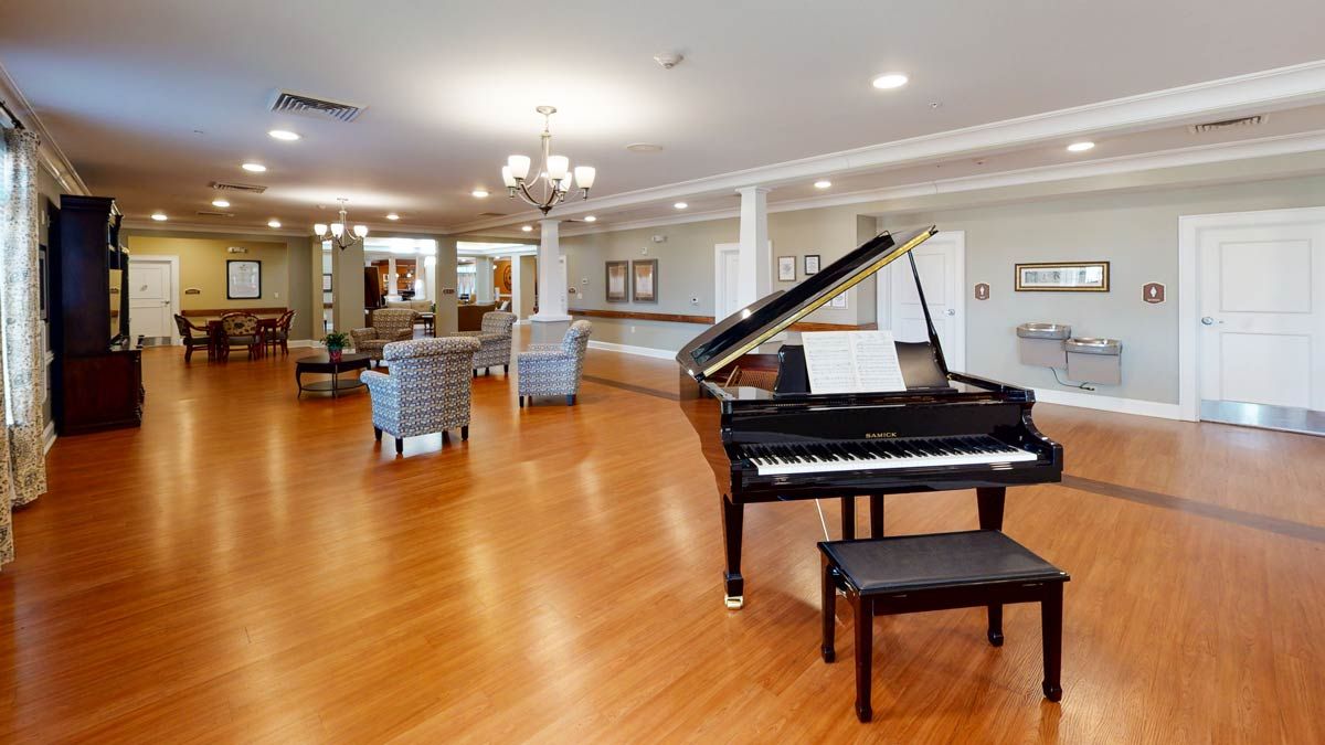 A spacious lobby area featuring a grand piano and comfortable seating.
