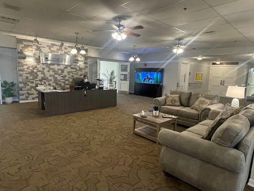 A cozy lounge area featuring comfortable sofas, a modern TV setup, and stylish decor.