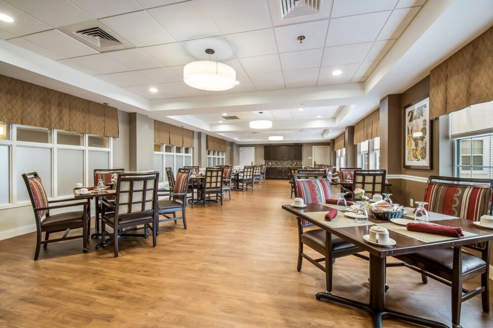 A spacious and elegantly decorated dining area with neatly arranged tables and chairs.