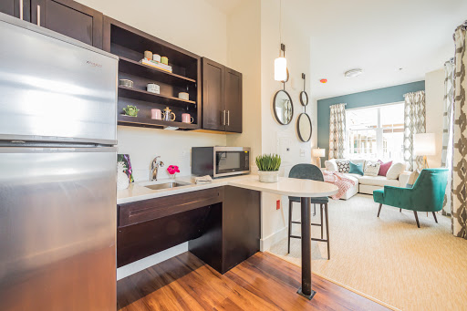 A stylish and modern kitchen featuring sleek cabinetry, essential appliances, and a cozy dining area.