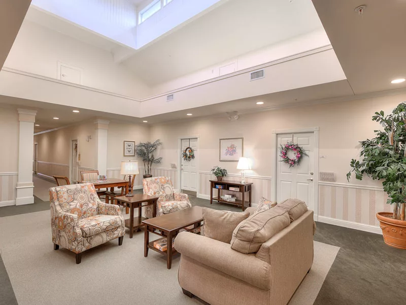 A cozy and inviting living room area with sofas, chairs, and tables arranged for comfort and conversation.