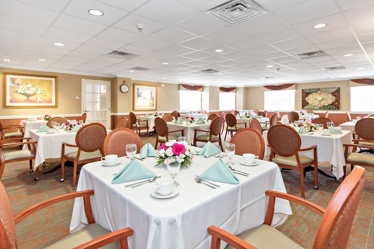 A well-arranged dining room with elegantly set tables and chairs.
