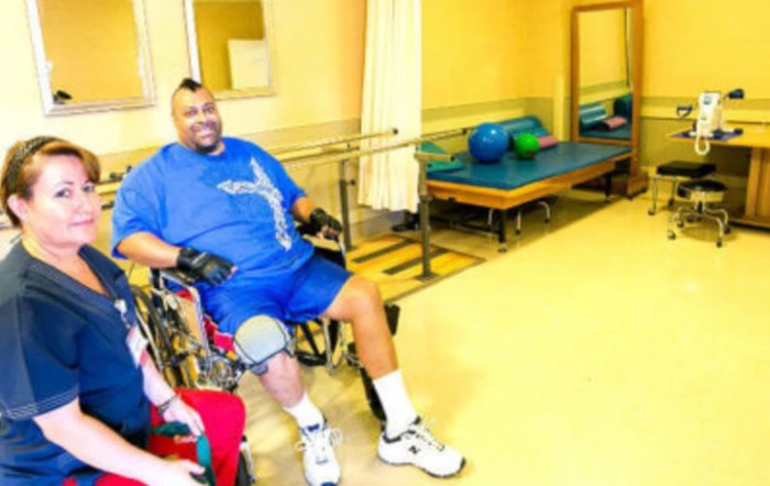 A person in a wheelchair engaging in a rehabilitation session indoors.