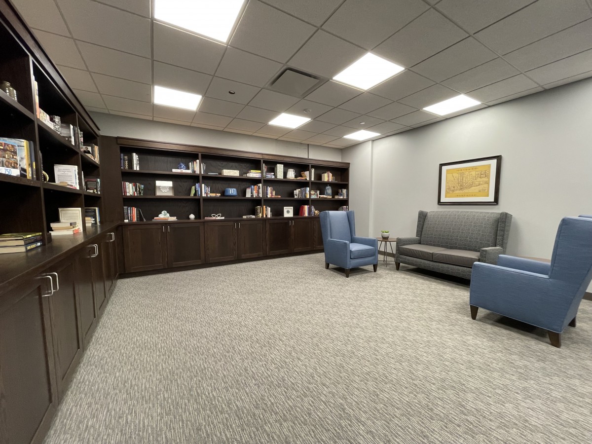 A cozy office lounge with bookshelves and comfortable seating.