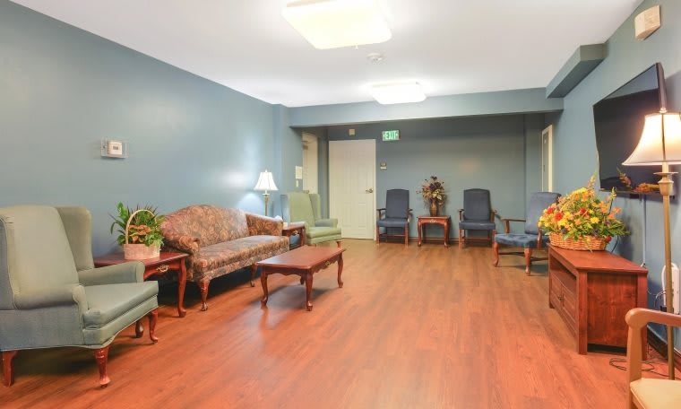 A cozy waiting room with seating and a wooden floor.