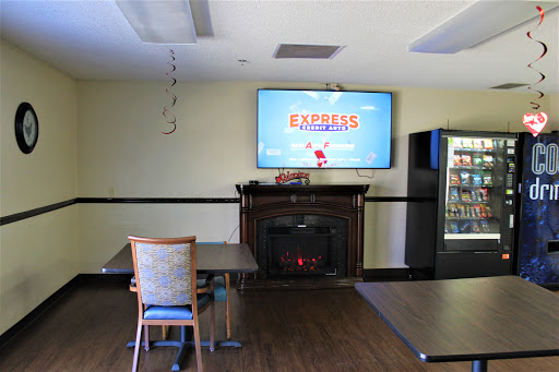 A cozy lounge space featuring a television, fireplace, and vending machine.