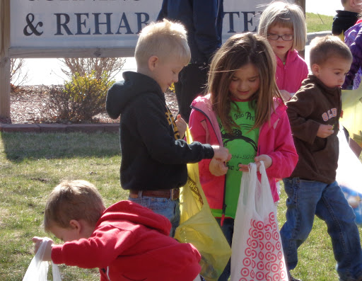 A group of children joyfully engaging in activities outside, showcasing a lively community spirit.
