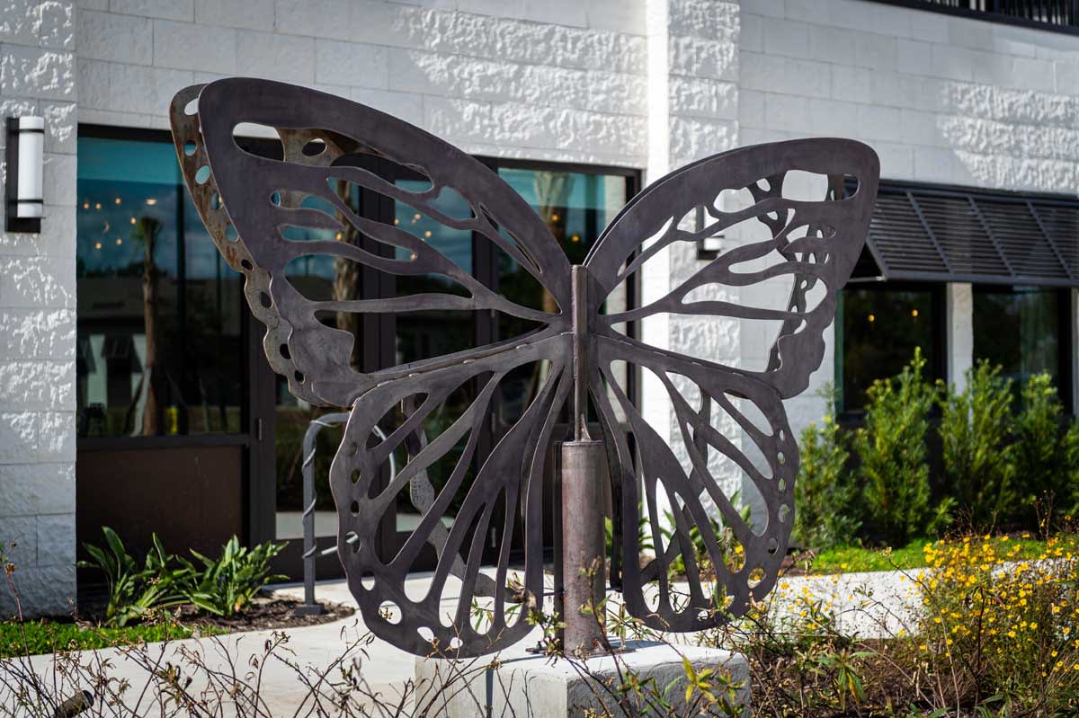 A large metal butterfly sculpture displayed outside.