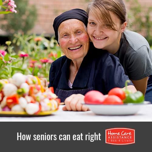 A senior enjoying a healthy meal with family in a garden.