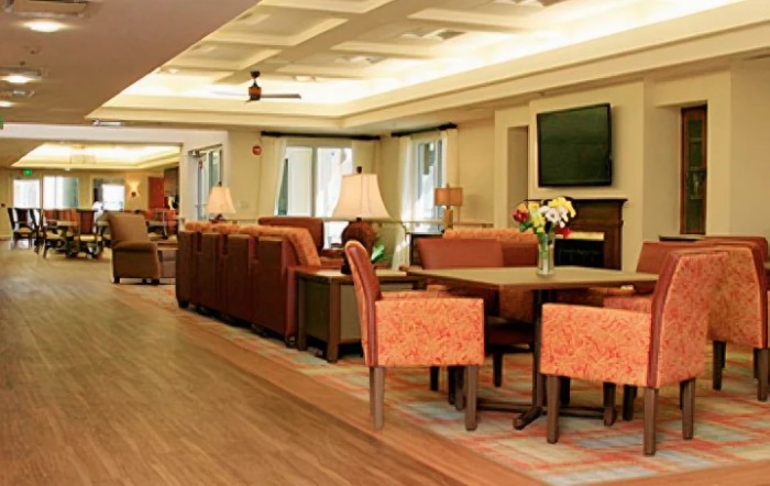 A cozy lounge area with comfortable seating and a television.