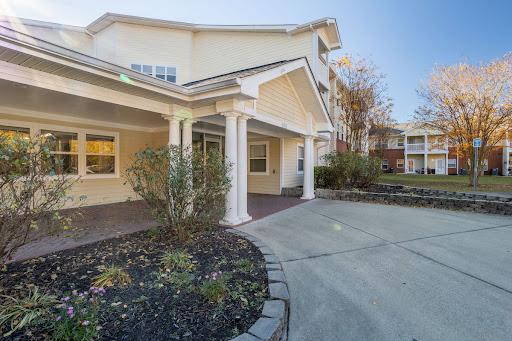 A welcoming entrance to a residential building with landscaped surroundings.
