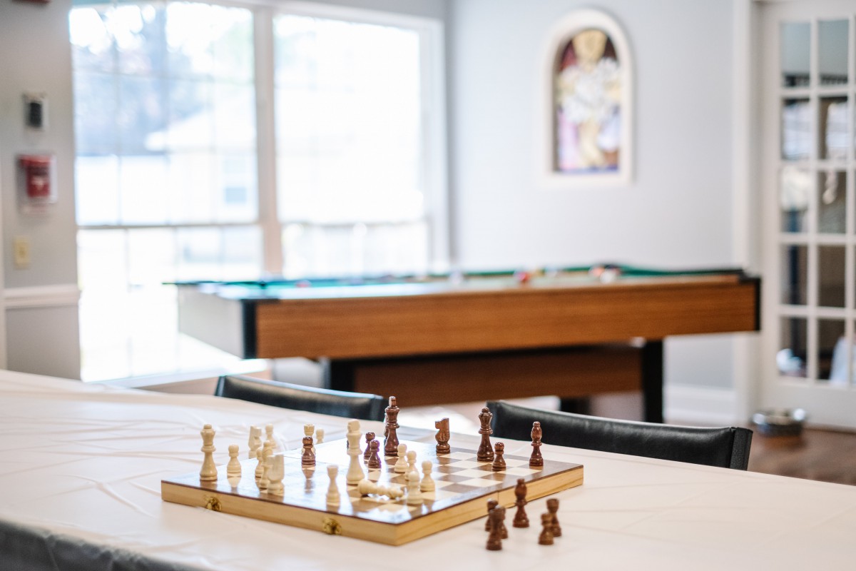 A cozy game room featuring a chessboard and pool table.