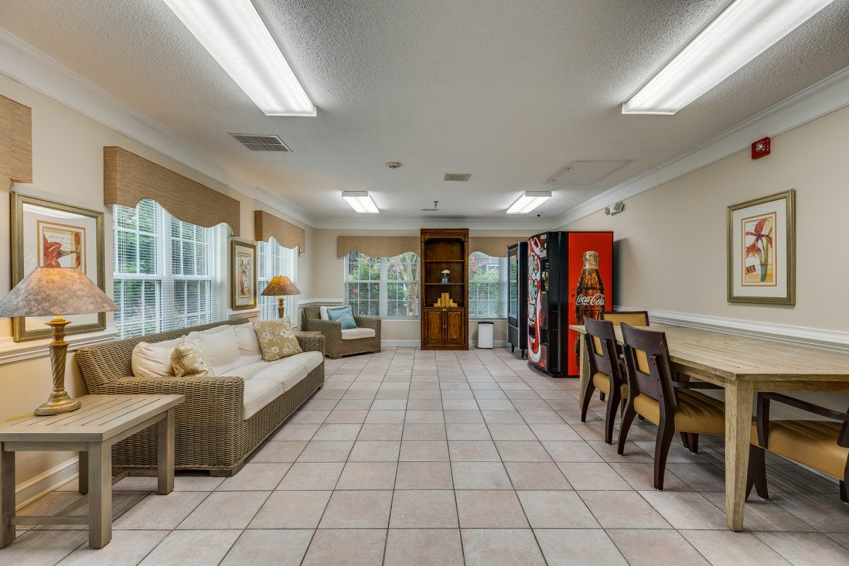 A well-lit room with comfortable seating, dining area, and vending machines.