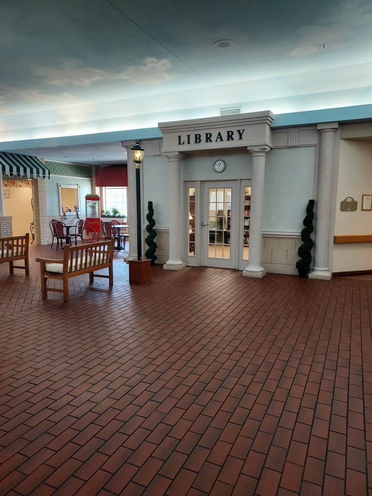An indoor library setting with seating areas and architectural features.