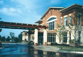 A modern commercial building with large windows and brick architecture.