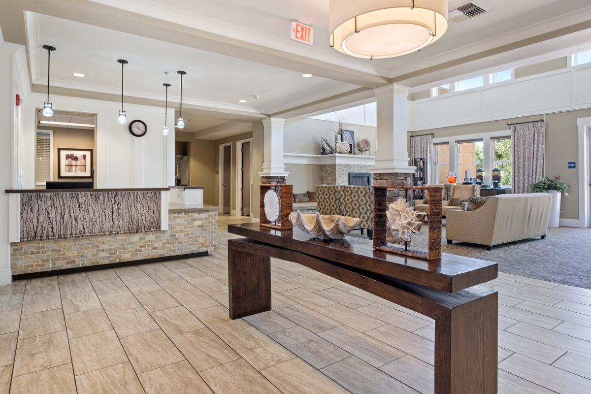 A spacious and elegantly designed hotel lobby featuring modern furniture and decor.