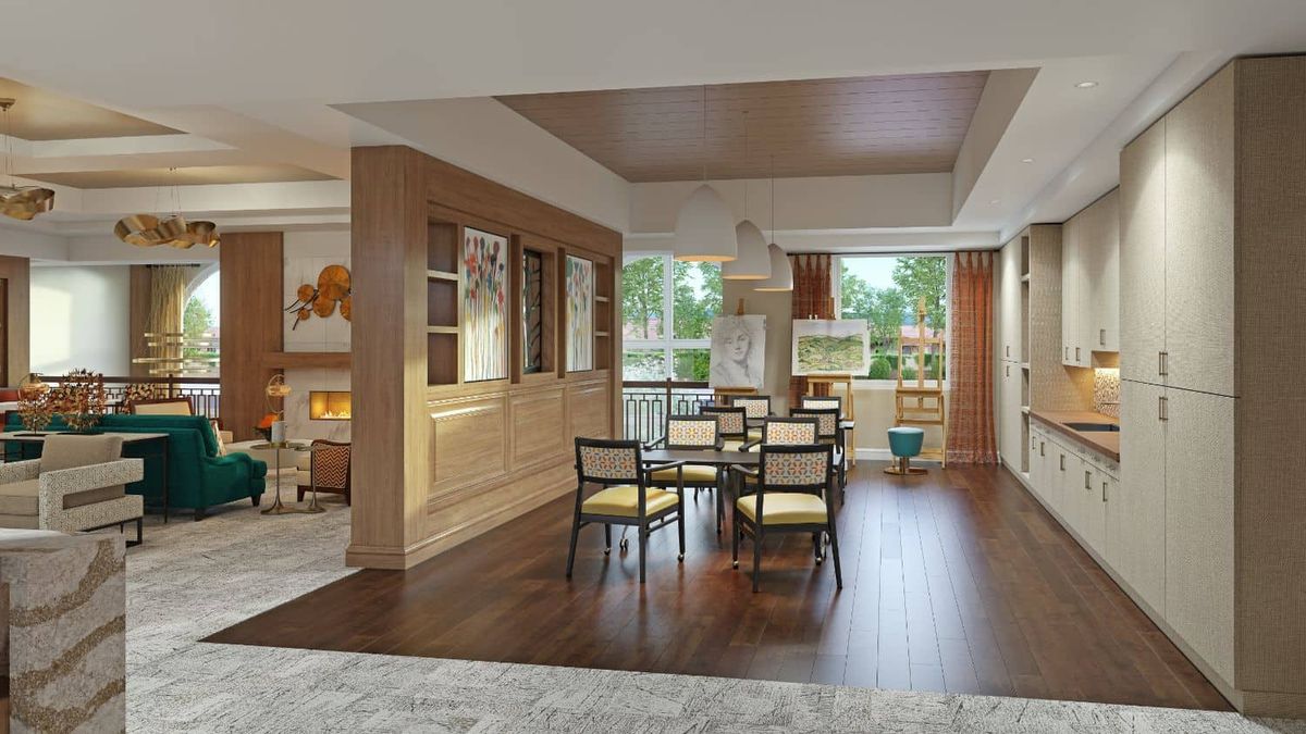A modern dining room with wood flooring and ample natural light.