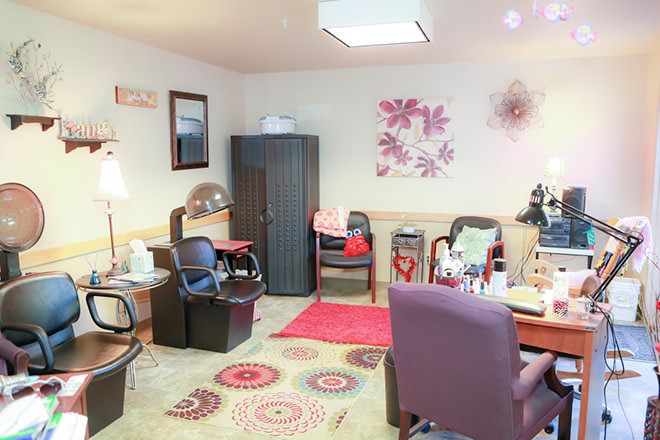A cozy office space with chairs, a desk, and colorful decor.