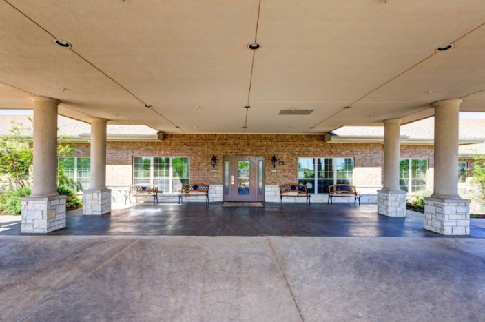 A covered entrance with columns leading to a building.