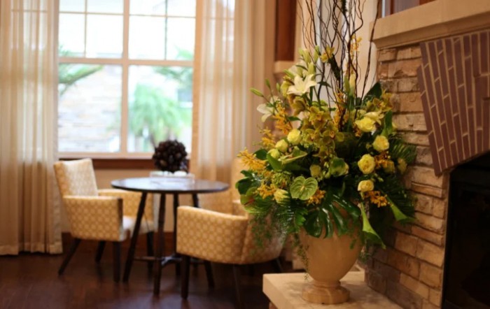 A cozy living room with elegant floral arrangements and comfortable seating.