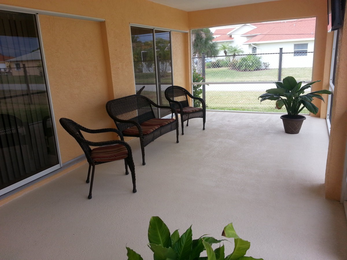 A cozy patio area with outdoor furniture and potted plants.
