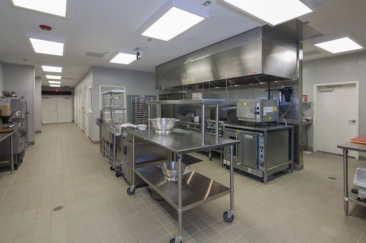 A clean and organized commercial kitchen with stainless steel equipment.