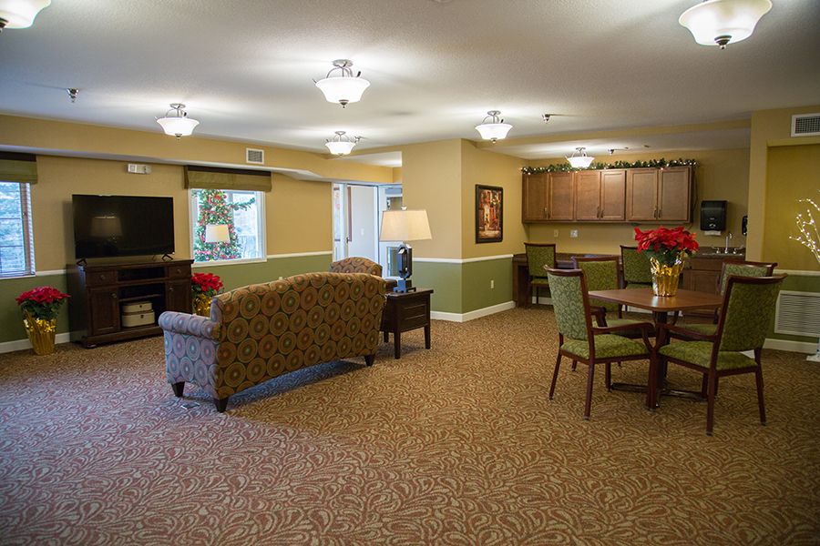 A spacious living room with comfortable seating, dining area, and warm lighting.