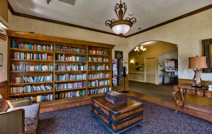 Cozy library with a large bookshelf and comfortable seating.