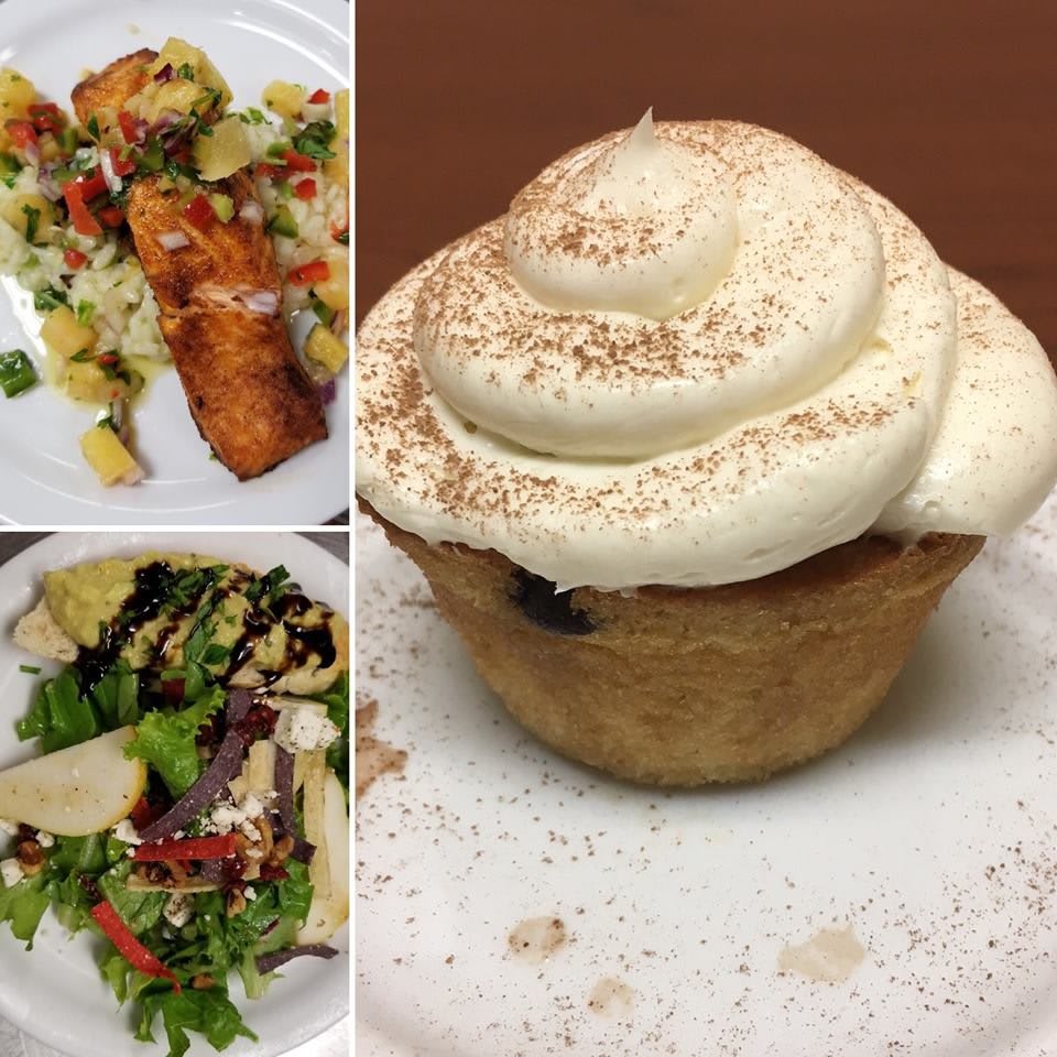 A delectable dinner spread featuring a savory main course, fresh salad, and a deliciously frosted cupcake for dessert.