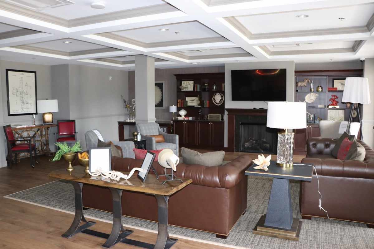 A stylish living room featuring a leather sofa, fireplace, and modern dcor.